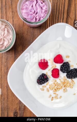 Yoghurt with oatmeal and fresh berries Stock Photo