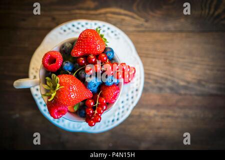 Fresh summer berries in a teacup Stock Photo