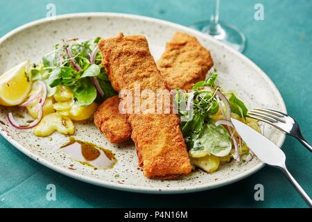 Baked carp with potato and lamb's lettuce Stock Photo