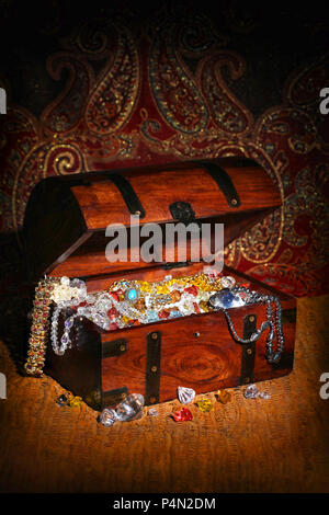 Treasure chest filled wiht precious stones and jewelry Stock Photo