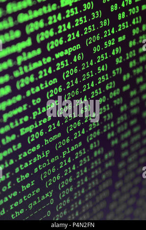Macro shot of the command line on the monitor of the office computer. The concept of the programmer's work. Information line flow . Stock Photo