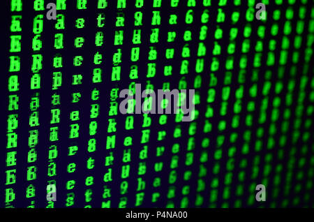 Macro shot of a glitch on the monitor of an office computer. The concept of introducing a virus into a personal data keeper. Stream of random green sy Stock Photo