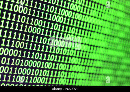 Macro shot of binary code on the monitor of an office computer. The concept of the programmer's work. The flow of digital information strings . Stock Photo