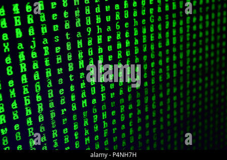 Macro shot of a glitch on the monitor of an office computer. The concept of introducing a virus into a personal data keeper. Stream of random green sy Stock Photo