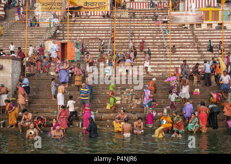 Unidentified people taking ritual bath in the river Gangain the holy city of Varanasi, India. Stock Photo