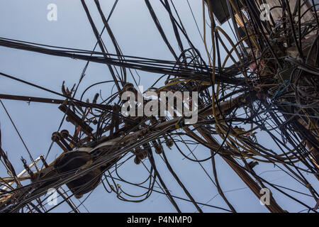 Wires attached to the electric pole, the chaos of cables and wires on an electric pole in New dehli, India, concept of electricity Stock Photo