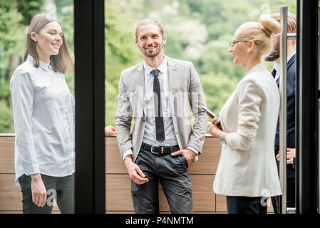 Business people on the office balcony during a break Stock Photo
