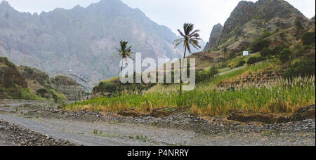 Panorama of dried canyon between fertile green valley and rugged cliffs. Santo Antao, Cabo Verde Stock Photo