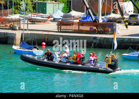 Weymouth, Dorset. 22nd June 2018. Visitors leave Weymouth harbour, heading out to sea for a cooling ride on a rib-boat Credit: stuart fretwell/Alamy Live News Stock Photo