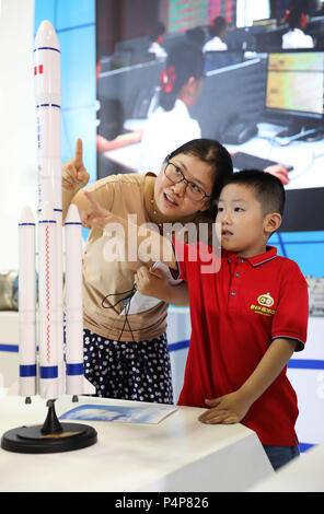 Chongqing. 23rd June, 2018. Visitors view a rocket model at an exhibition held in southwest China's Chongqing Municipality, June 23, 2018. The 9th China International Exhibition of Military and Civil Technologies kicked off Thursday in southwest China's Chongqing Municipality, drawing more than 200 delegations from China and abroad. The number of visitors to the exhibition peaked Saturday. Credit: Wang Quanchao/Xinhua/Alamy Live News Stock Photo