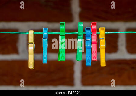 Colorful clothespin, clothespins on the rope close up. Stock Photo
