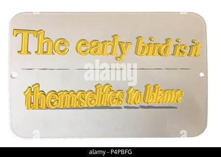 Old rusted tin sign enamelled with caption in English "The early bird itself to blame" Stock Photo