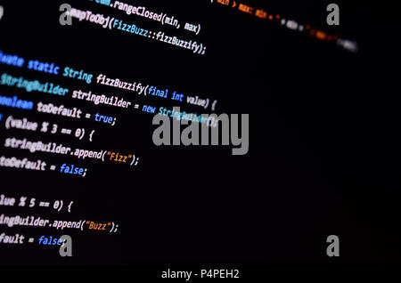 Macro shot of the command line on the monitor of the office computer. The concept of the programmer's work. Information line flow . Stock Photo