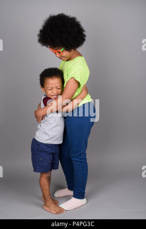 Young cute African brother and sister hugging Stock Photo