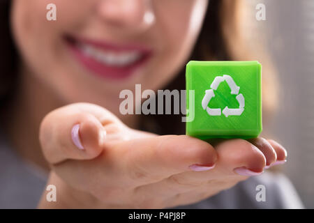 Close-up Of A Woman's Hand Holding Green Cubic Block With Recycle Symbol Stock Photo