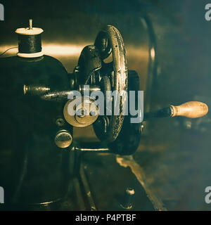 Old oiled up grungy  isolated vintage sewing machine. Close-up. Stock Image. Stock Photo