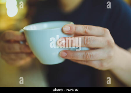 Cup of cappuccino on the table, coffee shop background. Marble texture. Close up Stock Photo