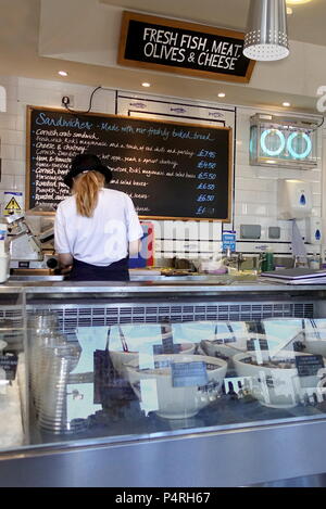 Padstow, Cornwall, April 11th 2018: Woman preparing food in a seafood speciality delicatessen Stock Photo