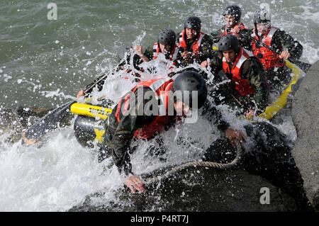 Students in Basic Underwater Demolition/SEAL Class 282 participate in rock portage in Coronado, Calif., April 13, 2010. (DoD Stock Photo