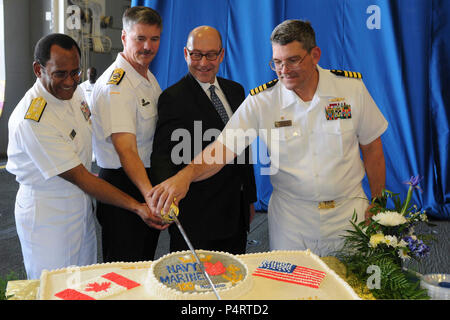 On board USS Wasp (LHD 1) from left to right, Vice Adm Melvin Williams Jr, commander Second Fleet, Vice Adm. Dean McFadden, Canada's Chief of Maritime Staff, U.S. Ambassador to  Canada, David Jacobson and Wasp Commanding Officer, Captain Lowell D. Crow cut the ceremonial cake marking Canada's Navy Centennial and International Fleet Review in Halifax, Nova Scotia.  Wasp is currently participating in the CNC/IFR that began on June 25 and concludes July 2. Wasp Sailors and Marines including embarked Carrier Strike Group 2, Helicopter Sea Combat Squadron 22 and 2nd Marines are participating in var Stock Photo