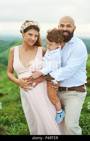 Young Hispanic Couple With Baby Standing Together Over Isolated 