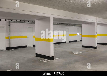 Typical underground car parking garage in a modern apartment house. Stock Photo