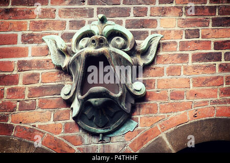 COPENHAGEN, DENMARK - architectural detail: bronze masque as brick facade decoration of the Ny Carlsberg brewery elephant gate and tower Stock Photo