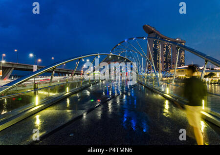 Beautiful blue hour Marina Bay Sands Hotel and Helix Bridge. These duo buildings had become iconic landmark for Marina Bay, Singapore. Stock Photo