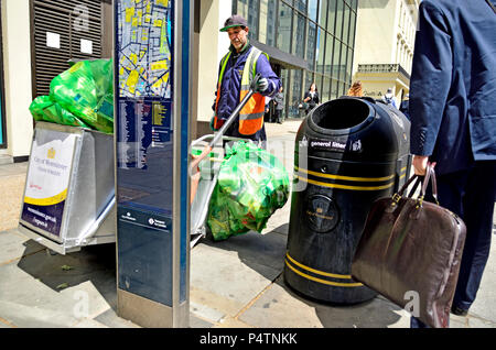 Street cleaner emptying rubbish bins in the Strand, central London, England, UK. Stock Photo