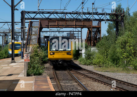 A British Rail Class 142 Pacer train passes through the run-down Ardwick railway station in Manchester. Stock Photo