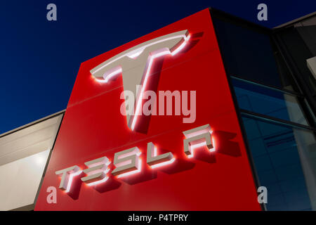 Signage for the Tesla motor company at nigtht outside one of its showrooms in South Manchester, UK. Stock Photo