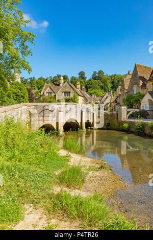 Castle Combe Wiltshire England June 22, 2018 Picturesque village scene of the bridge over By Brook Stock Photo