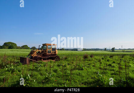 An Abandoned Bulldozer lies parked in a Field boundary close to the Village of Letham in Angus, Scotland on one Summers morning.