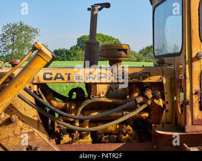 A Close up photograph showing the working pieces of the Caterpillar Bulldozer Engine in a piece of Plant, parked in a Farm Field near Letham in Angus,