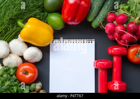 Composition with different fresh organic fruits and vegetables,  dumbbells and notebook. Copy space. Top view. Flat lay. Stock Photo