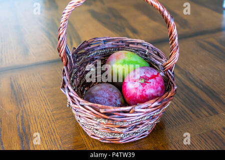 Red Mangoes arranged in Basket on Display Stock Photo