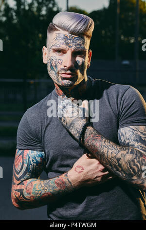 Portrait of tattooed young man outdoors Stock Photo