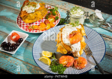 Baked Potato, sweet potato, Argentine red shrimp, sour cream on plate Stock Photo