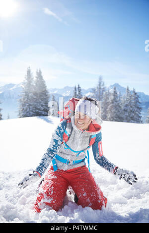 Austria, Tyrol, female hiker having fun in the snow Stock Photo