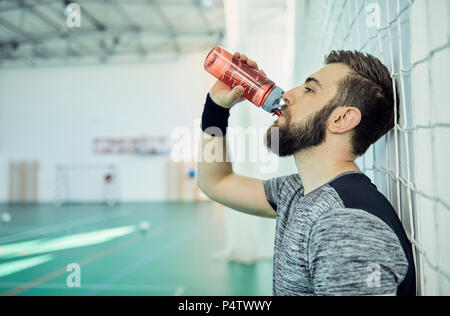 Basketball player drinking from plastic bottle Stock Photo