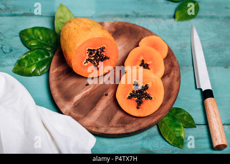 Sliced papaya on chopping board Stock Photo