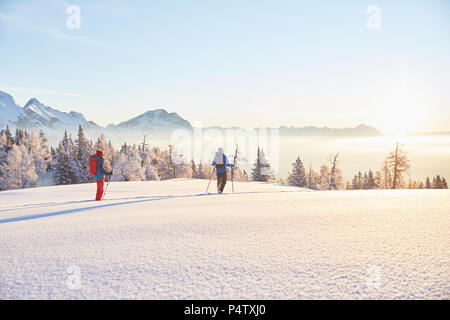 Austria, Tyrol, snowshoe hikers at sunrise Stock Photo