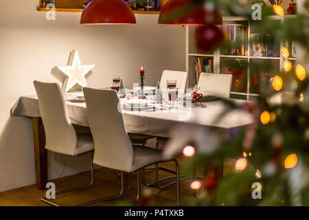 Laid table in dining room at Christmas time Stock Photo
