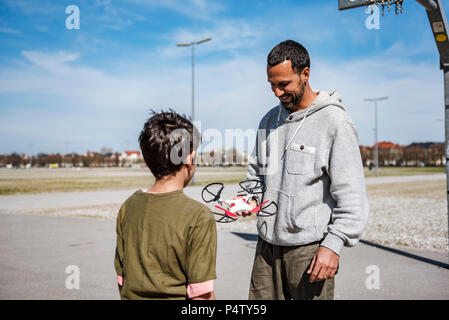Father and son flying drone Stock Photo - Alamy