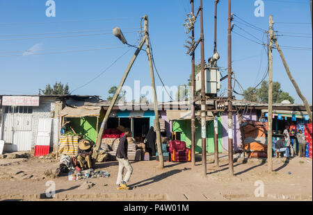 Addis Ababa, Ethiopia, January 30, 2014, Small shops on a dirt road with a few informal traders nearby Stock Photo