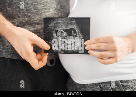 pregnant couple holding ultrasound scan Stock Photo
