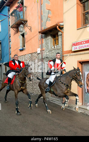 Couple ride reckless horserace 'Sa Carrela e Nanti', during the carnival at Santu Lussurgiu, Oristano, Sardinia, Italy, Europe Stock Photo