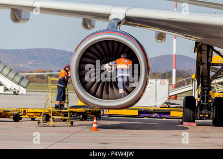 Russia, Vladivostok, 10/13/2017. Engineers check engine of jet aircraft after landing. Airbus A330 of Aeroflot Airlines. Aviation and equipment of air Stock Photo