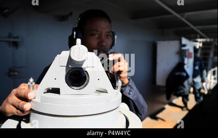 NEWS, Va. (May 9, 2017) Quarter Master 3rd Class Lashanda Hinton, from Raleigh, North Carolina takes bearings with an alidade on vultures row aboard the Nimitz-class aircraft carrier USS Abraham Lincoln (CVN 72) as Abraham Lincoln goes underway for the first time in four years. Abraham Lincoln is underway after successfully completing its mid-life refueling and complex overhaul and will spend several days conducting sea trials, a comprehensive test of many of the ship’s key systems and technologies. Stock Photo