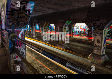 The cars passing through the graffiti-lined Krog Street Tunnel, Atlanta, Georgia Stock Photo
